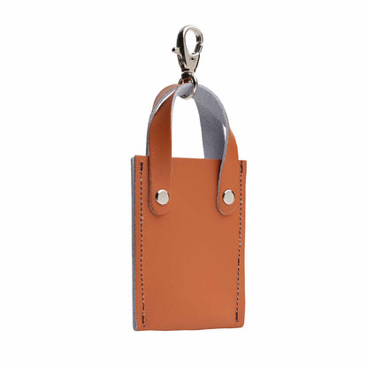 Luxury hand-crafted mini tote bag charm in burnt orange, made of genuine leather, showcasing elegant craftsmanship and vibrant colour. Perfect accessory to enhance handbags and keychains.