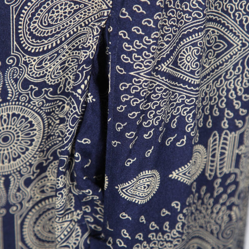 Model wearing an elegant mandala print cami jumpsuit, demonstrating its flowy silhouette and comfortable fit, styled with a long sleeve top underneath.