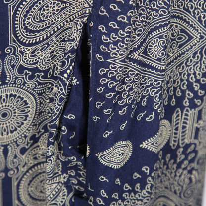 Model wearing an elegant mandala print cami jumpsuit, demonstrating its flowy silhouette and comfortable fit, styled with a long sleeve top underneath.