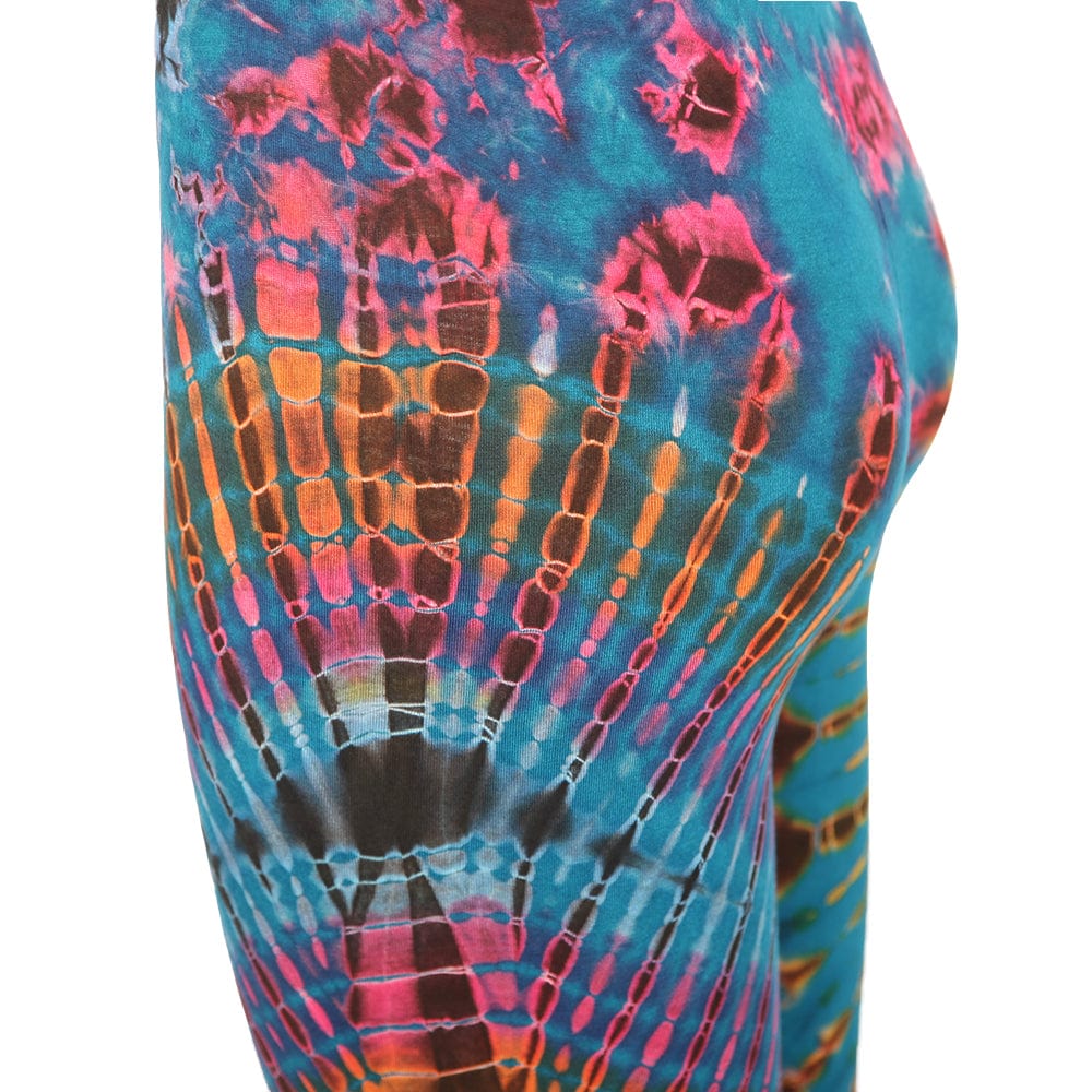 A model elegantly displaying colourful tie-dye yoga leggings, capturing the essence of festival fashion with a bohemian flair.