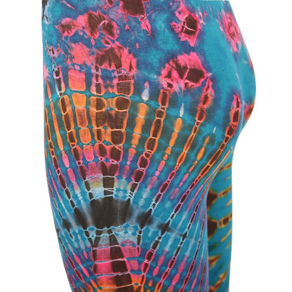 A model elegantly displaying colourful tie-dye yoga leggings, capturing the essence of festival fashion with a bohemian flair.