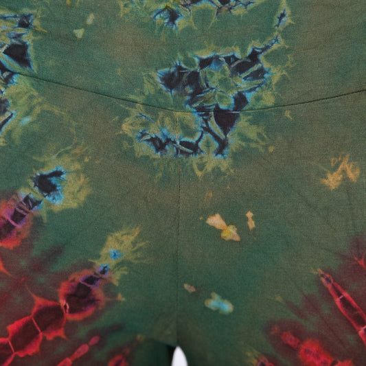 Close-up view of high waisted tie dye leggings featuring intricate designs and textures, made from soft, stretchy rayon and spandex for a luxurious fit.