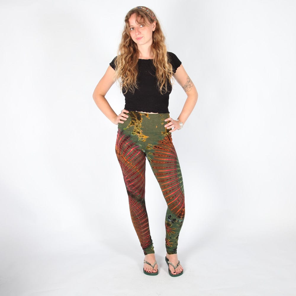 Model showcasing high waisted tie dye leggings in a chic setting, highlighting their versatile use and unique fashion statement.