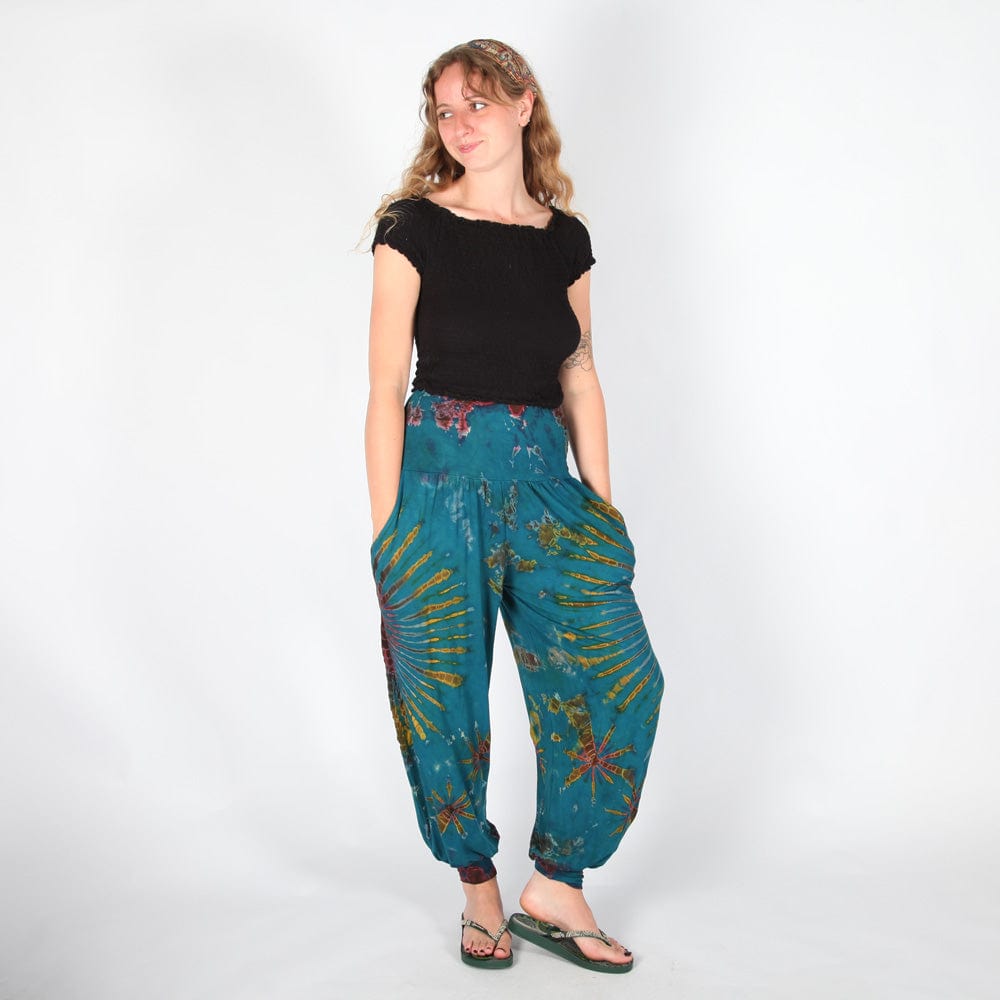 Vibrant purple tie dye harem pants with elasticated waist, crafted for comfort and sophistication, perfect for pairing with stylish tops.