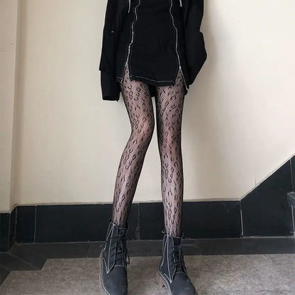 Full body shot of a model wearing Women's Luxury Fishnet Design Tights with a trendy outfit, highlighting modern fashion elegance.