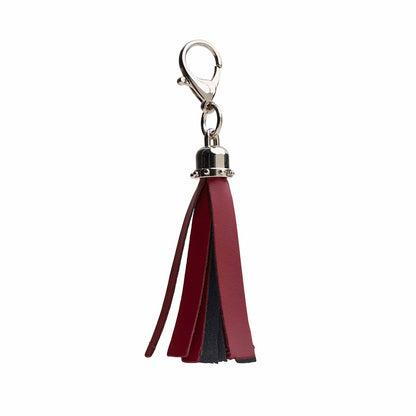 Exquisite handcrafted oxblood mini tassel bag charm by Zatchels, showcasing luxurious leather craftsmanship and chic design for haute couture accessories.