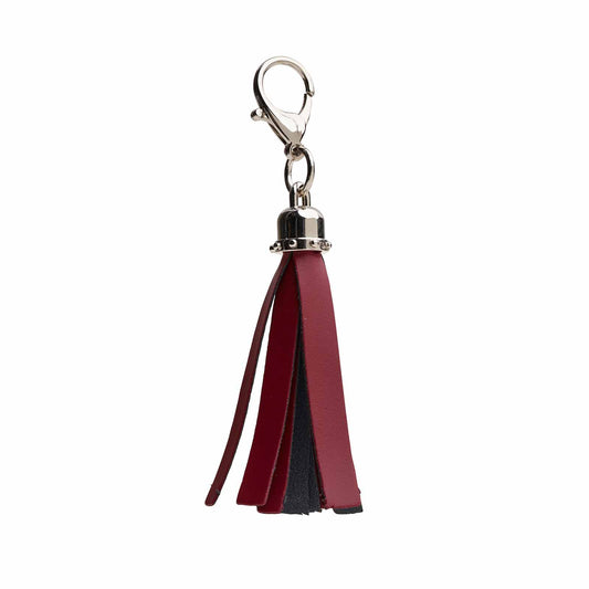 Exquisite handcrafted oxblood mini tassel bag charm by Zatchels, showcasing luxurious leather craftsmanship and chic design for haute couture accessories.