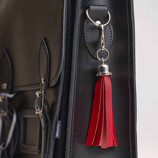 Luxury hand-crafted red mini tassel bag charm, a premium leather accessory enhancing the elegance of handbags and keys, measuring 100 x 20 mm.