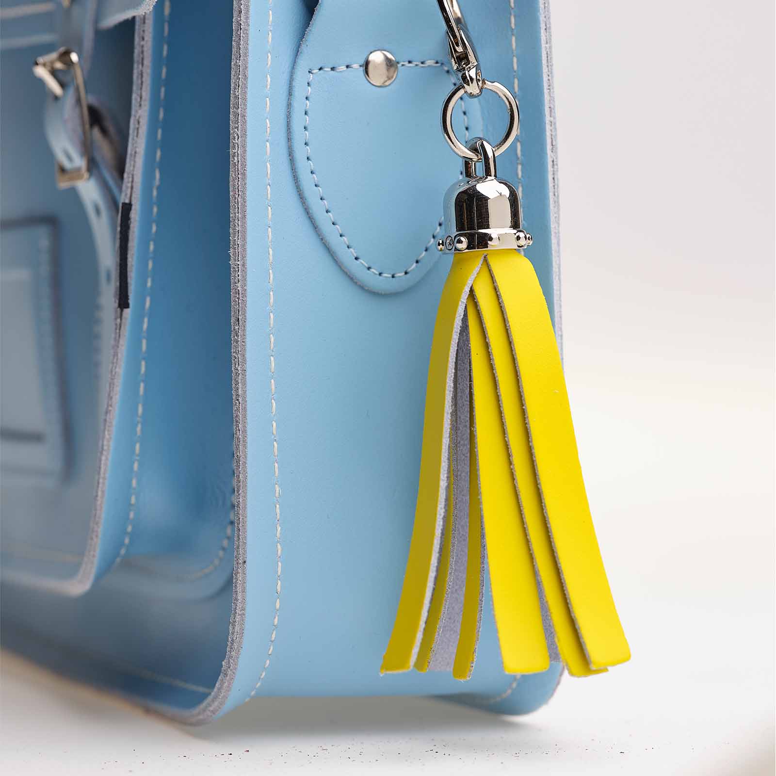 Luxury handcrafted pastel yellow mini tassel bag charm made from premium leather, featuring an elegant design, perfect for enhancing your accessories and elevating your style.