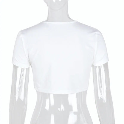 Dazzling Dreams Studio Women's Bless Up Embroidered Crop Tee showcased on a model in a stylish urban setting, highlighting its chic slim fit and luxurious embroidered detail.