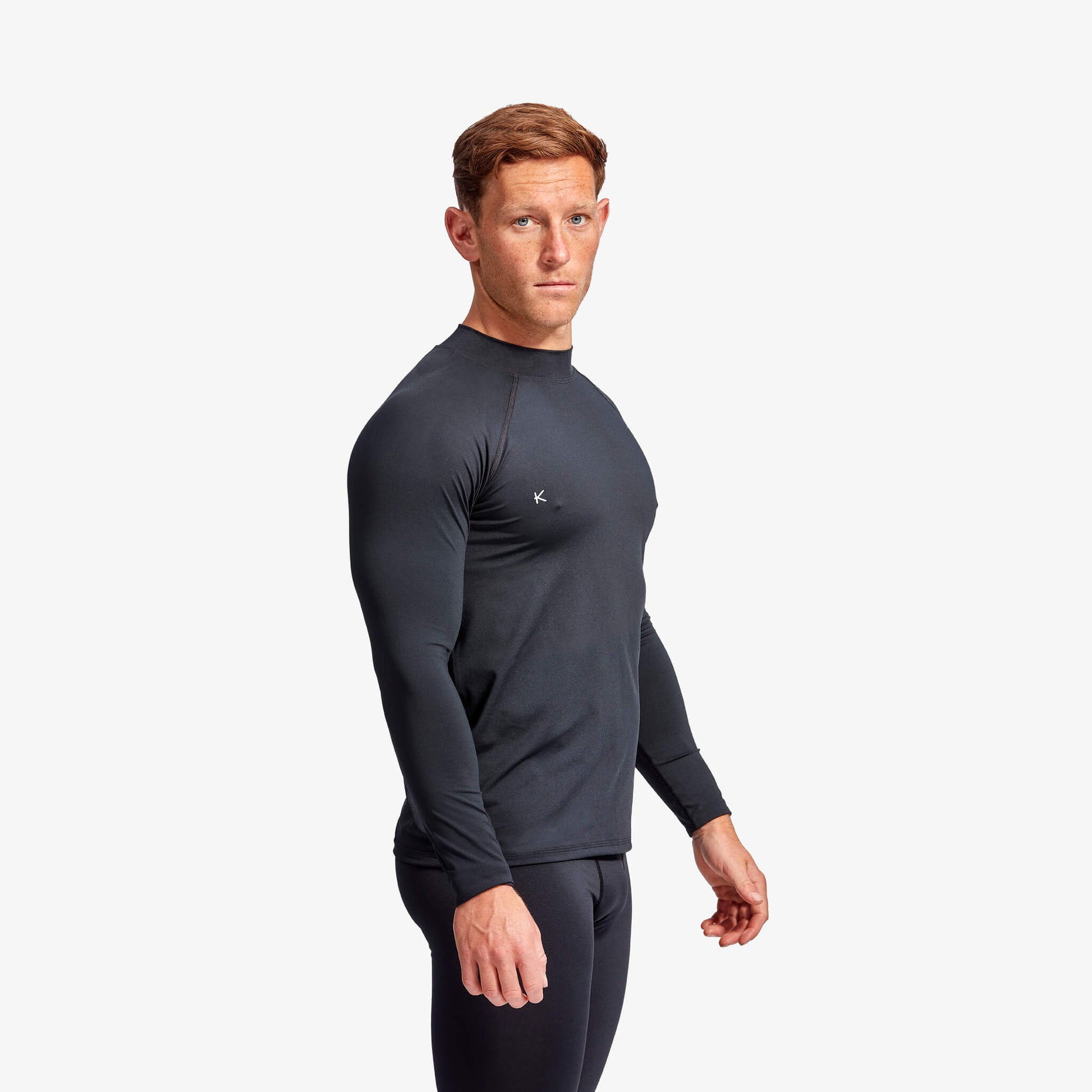 Close-up of KYMIRA Men's Long Sleeve Infrared Recovery Baselayer showcasing its durable fabric and triple stitched hems for maximum endurance during workouts.