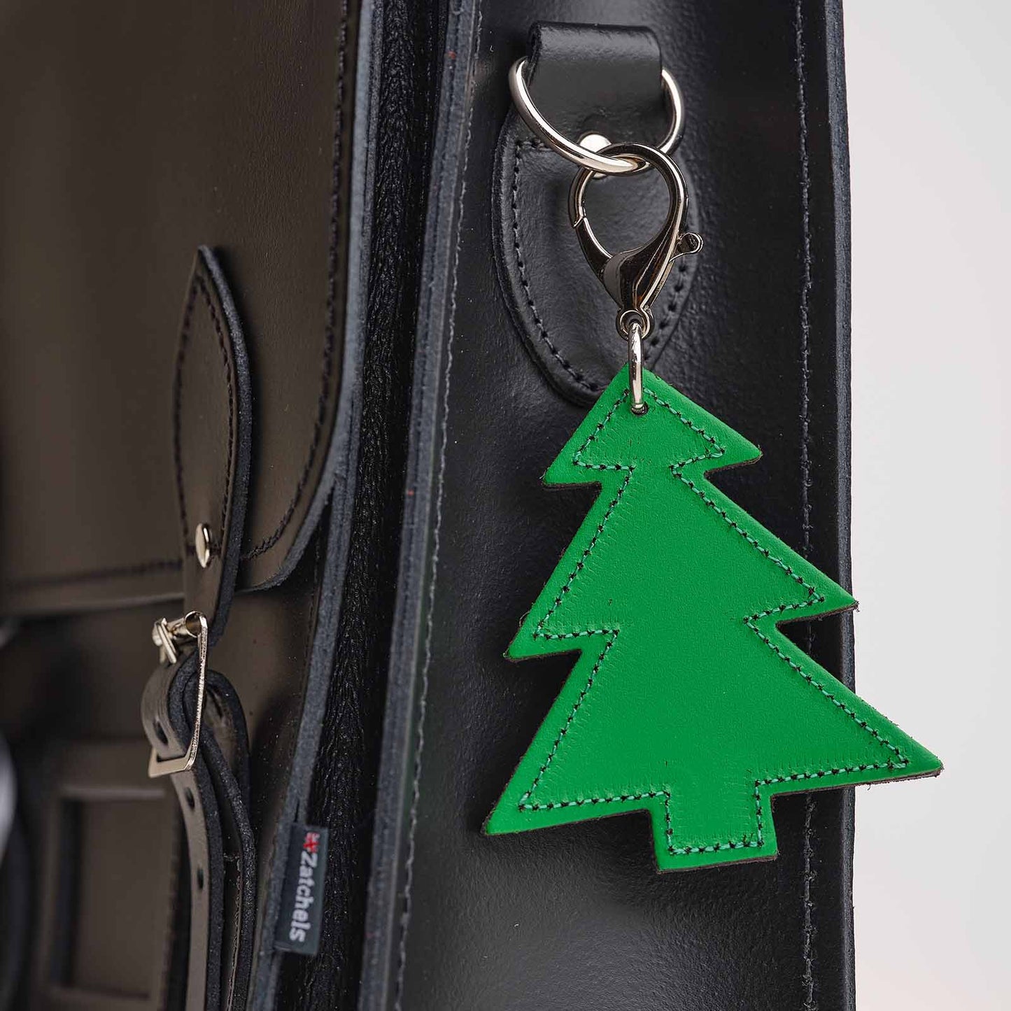 Luxury hand-crafted leather Christmas tree bag charm by Zatchels, showcasing exquisite detail and elegant design in a festive aesthetic.