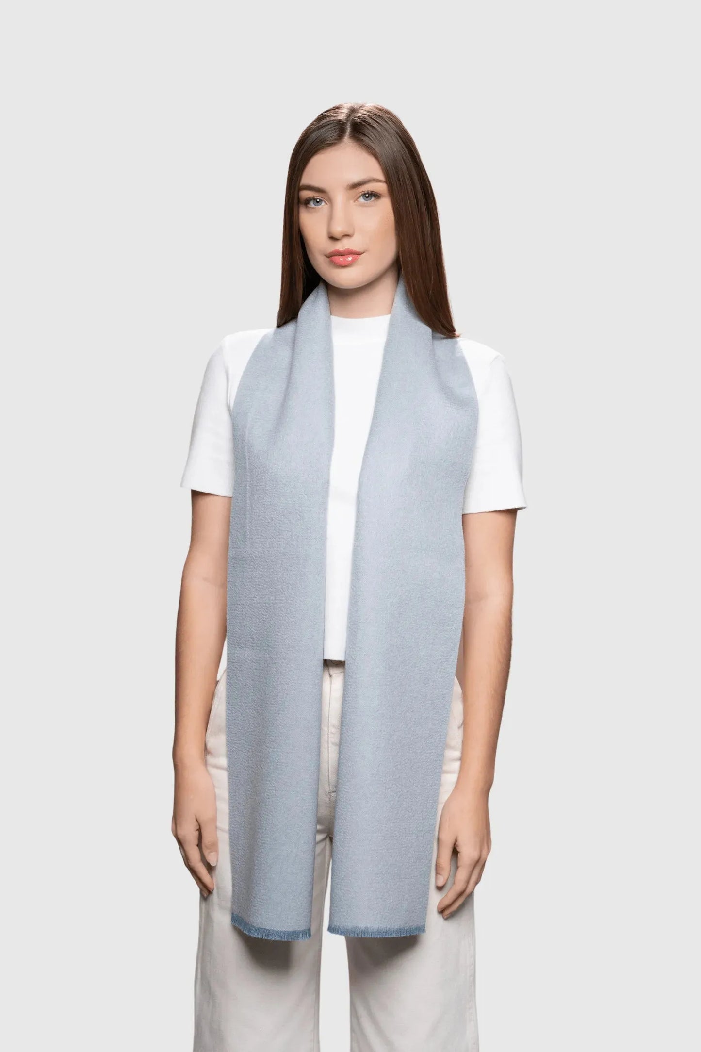 Close-up view of the delicate frayed edges of the reversible baby alpaca scarf, representing exceptional craftsmanship and luxury.