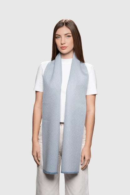 Close-up view of the delicate frayed edges of the reversible baby alpaca scarf, representing exceptional craftsmanship and luxury.