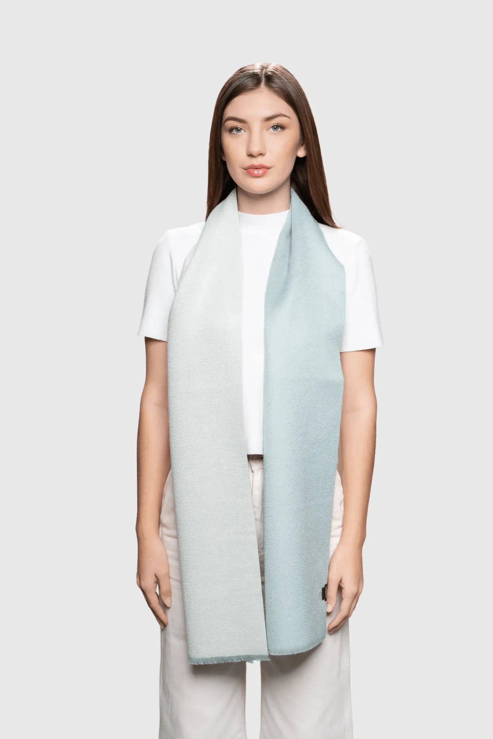 Luxurious baby alpaca reversible scarf showcasing two tone design with frayed edges, perfect for elegant winter styling.