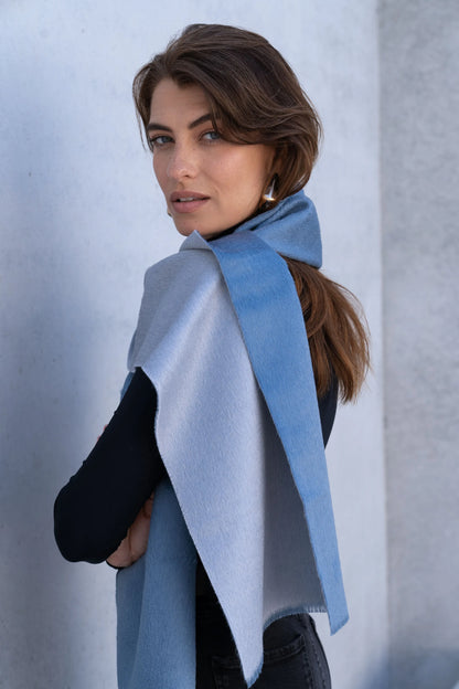 Baby alpaca reversible scarf draped elegantly, displaying its glamorous two tone hues suitable for both casual and formal outfits.