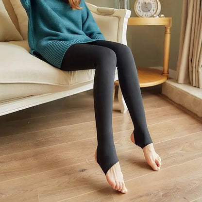 Women's Luxury Transparent Fishnet Tights, showcasing a soft nylon design, elegantly styled on a seated model wearing a teal sweater.