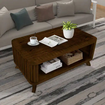 Stylish walnut rectangular wooden coffee table with open storage shelf, adorned with a decorative plant and a cup, set in a modern living room with neutral tones.
