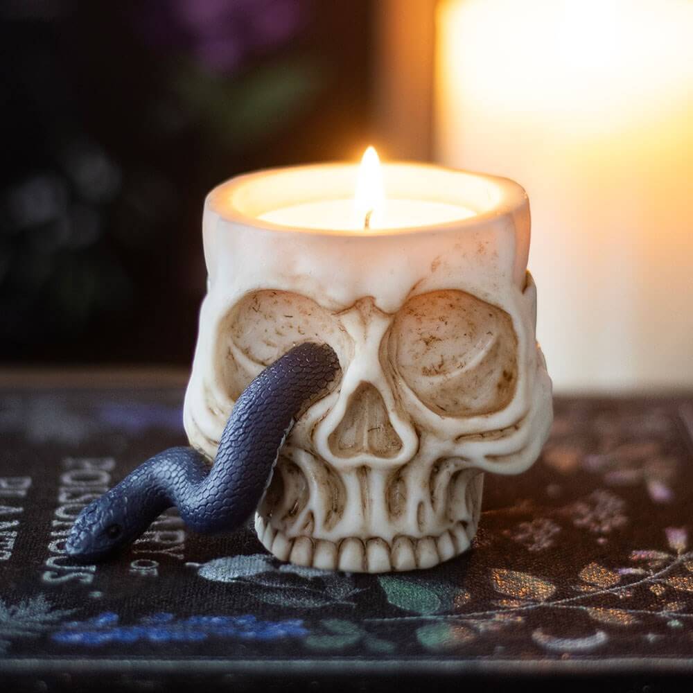 Artistic view of the enchanting gothic skull tealight holder entwined with a serpent, ideal for creating dramatic lighting and spooky atmosphere.