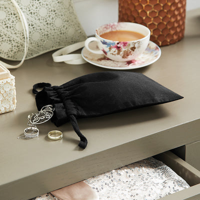 Beautifully arranged Luxury Organic Cotton Drawcord Bags in various sizes, showcasing their practicality and elegant appeal.