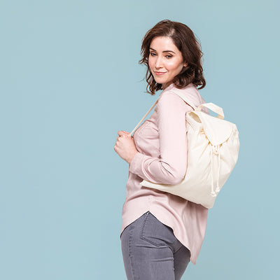 Close-up of the drawcord closure and wooden buttons of an eco-friendly backpack, highlighting premium craftsmanship and attention to detail.