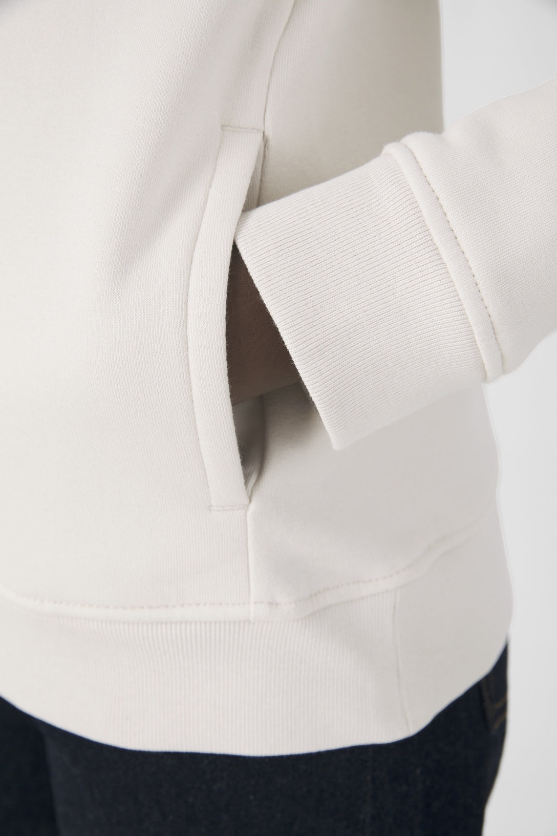 Elegant women's organic essential hoodie in soft grey, featuring 80% organic cotton for ultimate comfort and style.