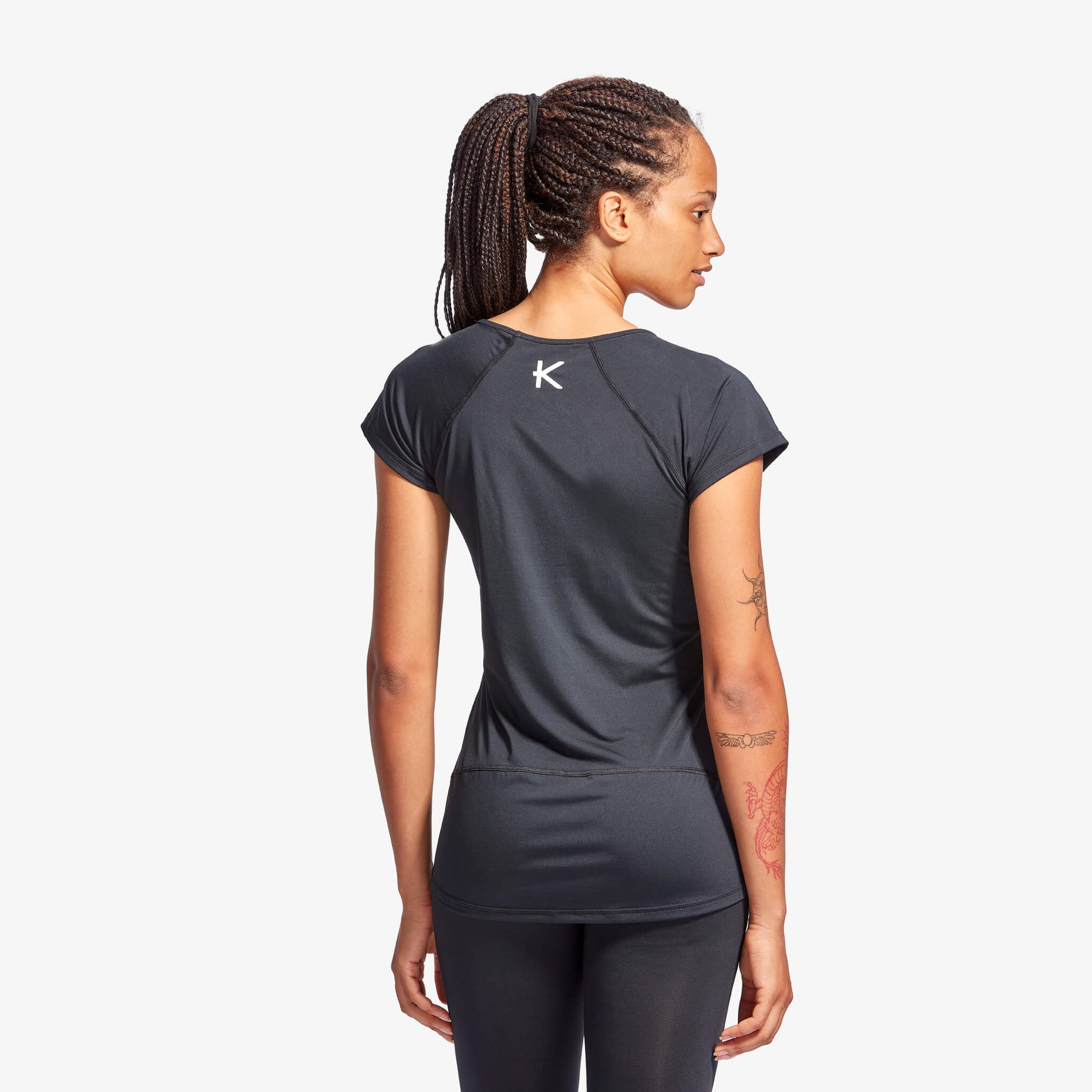 Close-up of KYMIRA women's infrared performance cap sleeve top showcasing the luxurious fabric texture and minimalist branding, perfect for enhancing comfort and style.