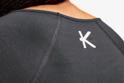 KYMIRA women's infrared cap sleeve top displayed elegantly on a mannequin, illustrating the functional design with empire waist and forward side seams for a flattering fit.