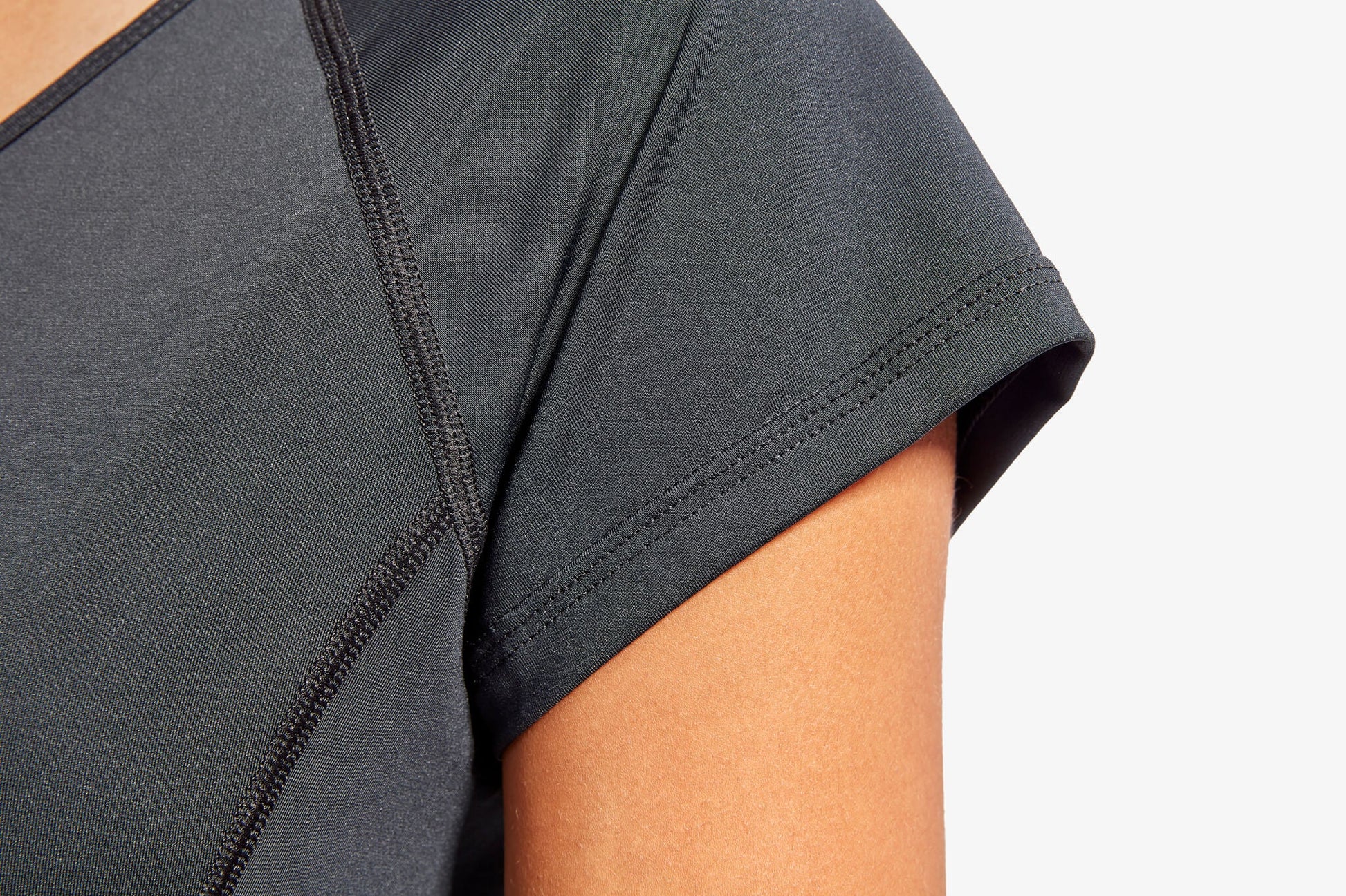 KYMIRA women's infrared performance cap sleeve top in an outdoor setting, demonstrating its versatility for workouts and casual wear, combining style with recovery benefits.