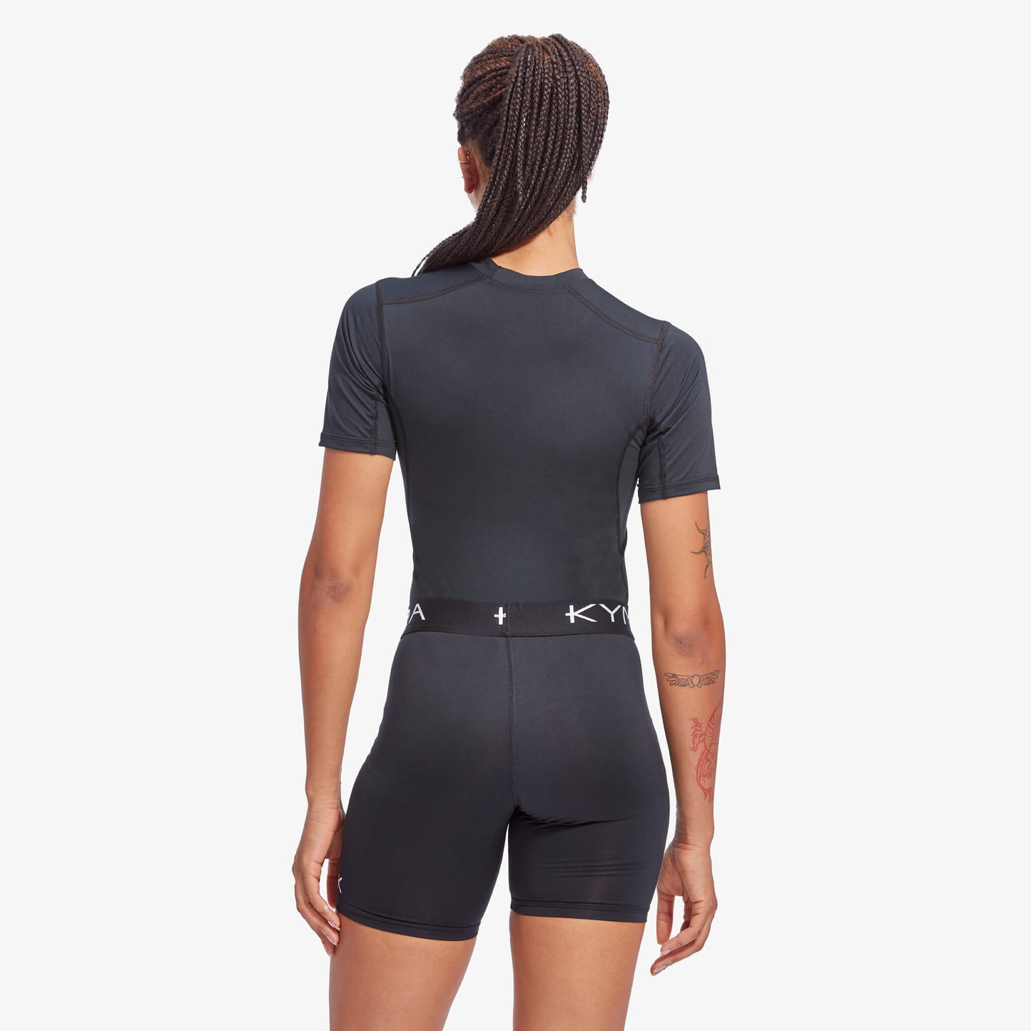 Stylish Women's KYMIRA IR50 Infrared Performance Baselayer Top modelled outdoors, emphasising its elegant design and advanced recovery technology.