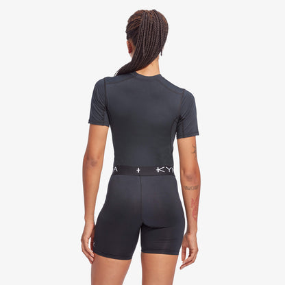 Stylish Women's KYMIRA IR50 Infrared Performance Baselayer Top modelled outdoors, emphasising its elegant design and advanced recovery technology.