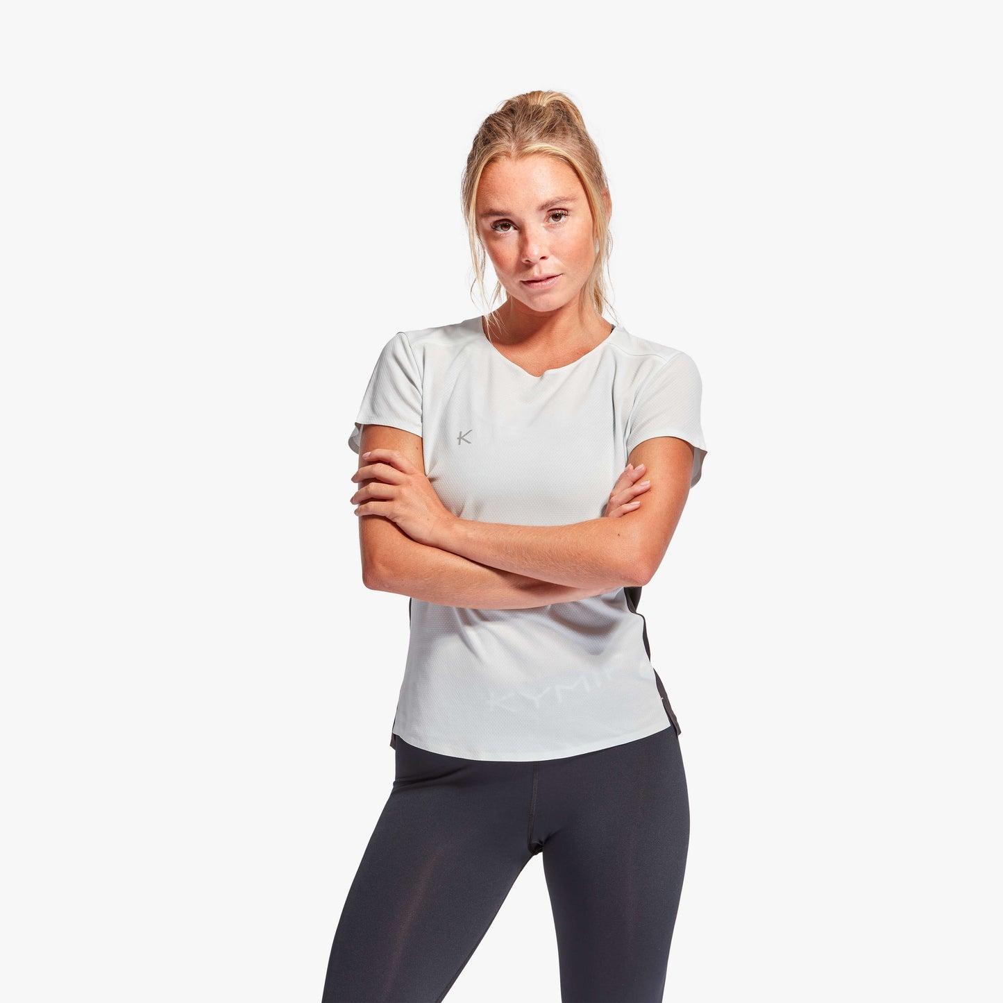 Close-up view of KYMIRA Women's infrared performance t-shirt, highlighting its lightweight and durable fabric for high-end athletic wear.