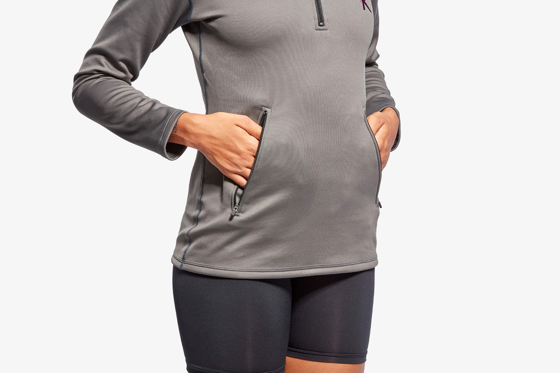 Detail of zip secured pockets on KYMIRA women's infrared fleece, designed for functionality and stylish outdoor functionality.