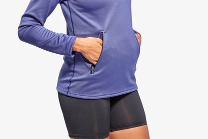 Stylish half zip fleece top from KYMIRA, demonstrating active fit and two zip-secured pockets for convenience.