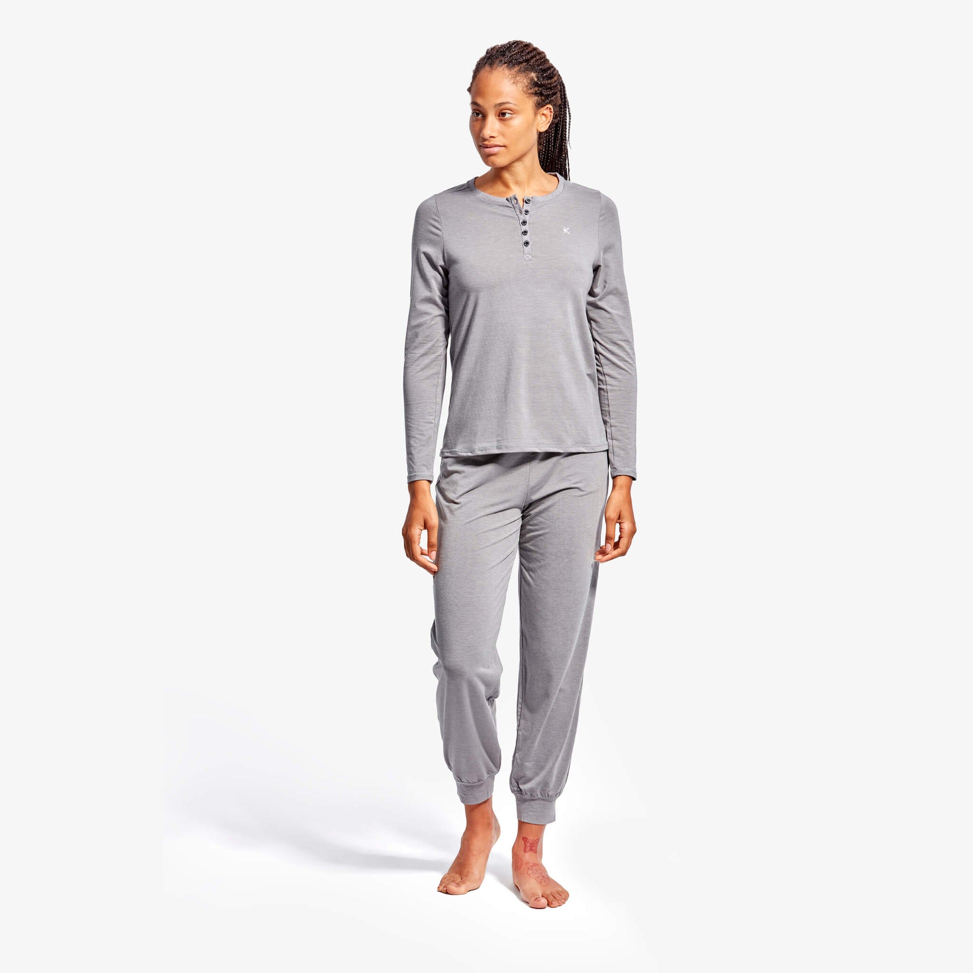 Model wearing KYMIRA Women's Infrared Recovery Henley Sleepwear Top, highlighting its stylish long sleeve design and elegant fit for a restful night.