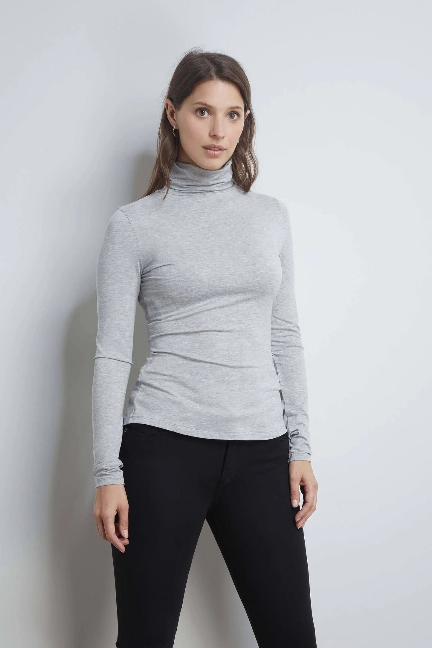 Women’s luxurious roll neck TENCEL™ Micro Modal top showcasing its elegant drape and sophisticated design in a soft fabric.