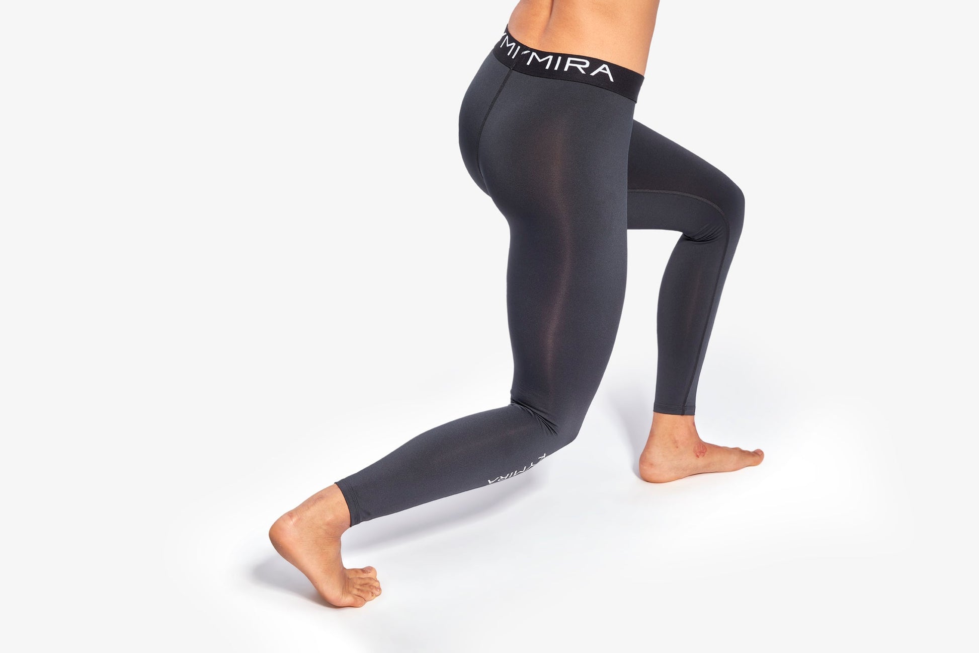 Close-up of KYMIRA women's fitted performance leggings showcasing flatlock stitching and breathable fabric, perfect for elite athletic comfort.
