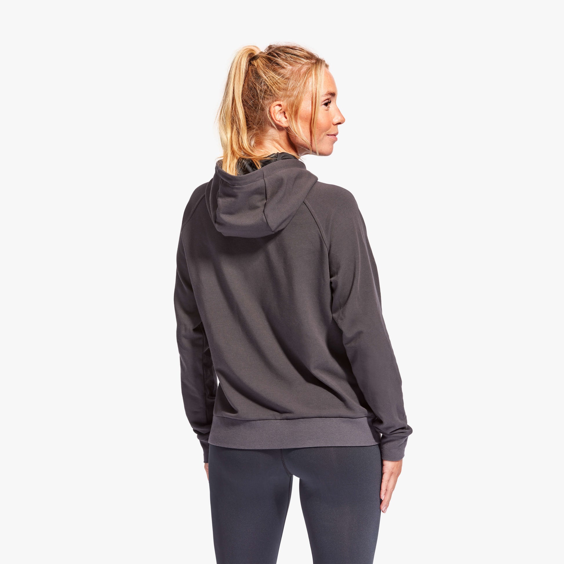 Stylish KYMIRA women’s tracksuit top in action, showcasing CELLIANT polyester fabric designed for warmth and recovery benefits post-training.