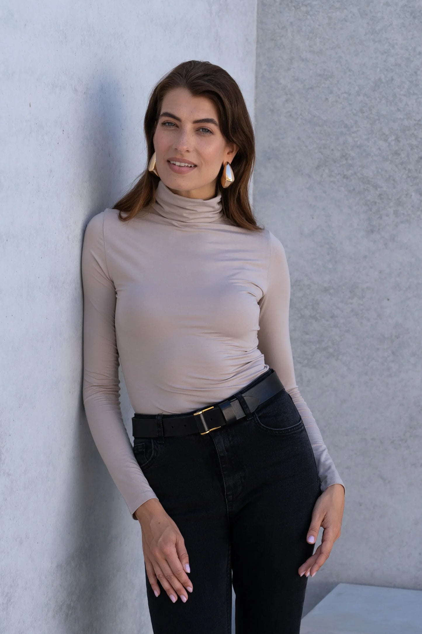 Collage of Women's Roll Neck TENCEL™ Micro Modal Top in various stylish outfits, showcasing its chic adaptability for transitional seasons.