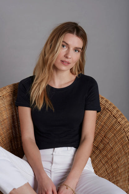 Close-up of soft linen texture of a women's t-shirt, highlighting the natural, moisture-wicking properties ideal for warm weather.