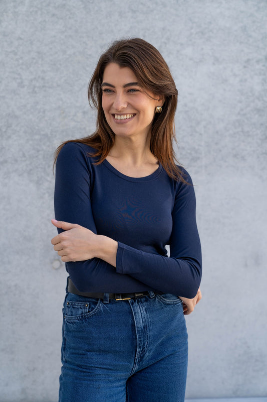 Luxury women's long sleeve scoop neck t-shirt in soft cotton modal blend, elegantly displayed on a neutral background highlighting its breathable fabric and timeless design.