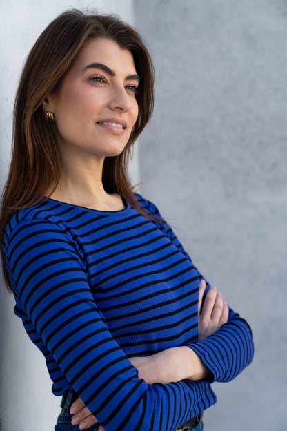 Close-up view of the soft organic cotton texture of the women's striped crew neck t-shirt, emphasizing its premium quality and comfort.