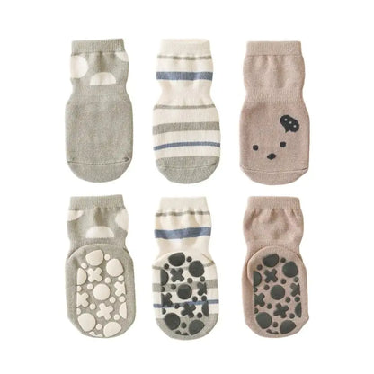 Sophisticated Women's Girls Non-Slip Safety Winter Warmer Grippy Socks in stylish grey with playful patterns, providing both fashion and functionality for luxurious winter comfort.