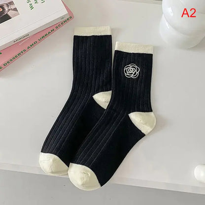 Luxurious Women's Tie-Dye Middle Tube Socks showcasing a chic black design with elegant white detailing, ideal for a sophisticated look and all-day comfort.