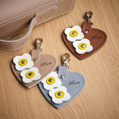 Elegant Zatchels Luxury Leather Love Heart Bag Charm, showcasing exquisite flower appliques and embossed logo, ideal for enhancing any handbag.