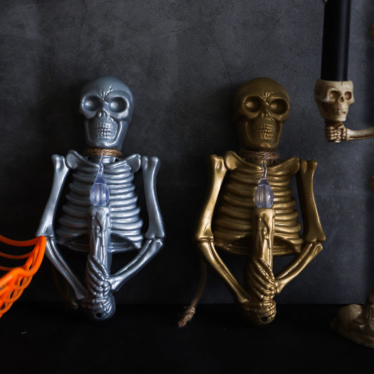 Halloween Decoration Skull Lamp Horror Atmosphere Arrange Hangings depicting a captivating silver skeleton with a glowing blue candle.
