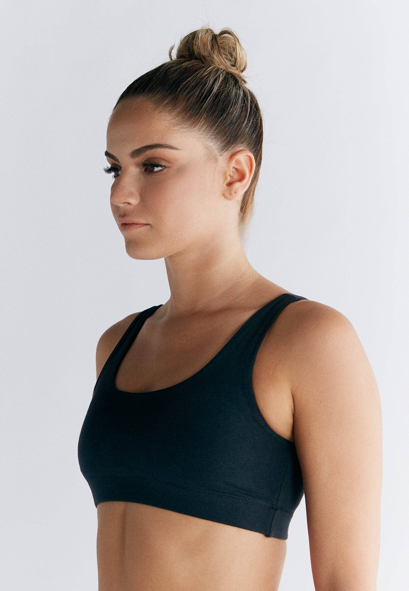 Close-up of the wide elastic underband of an organic cotton bralette, offering subtle lift and secure fit in luxury lingerie.