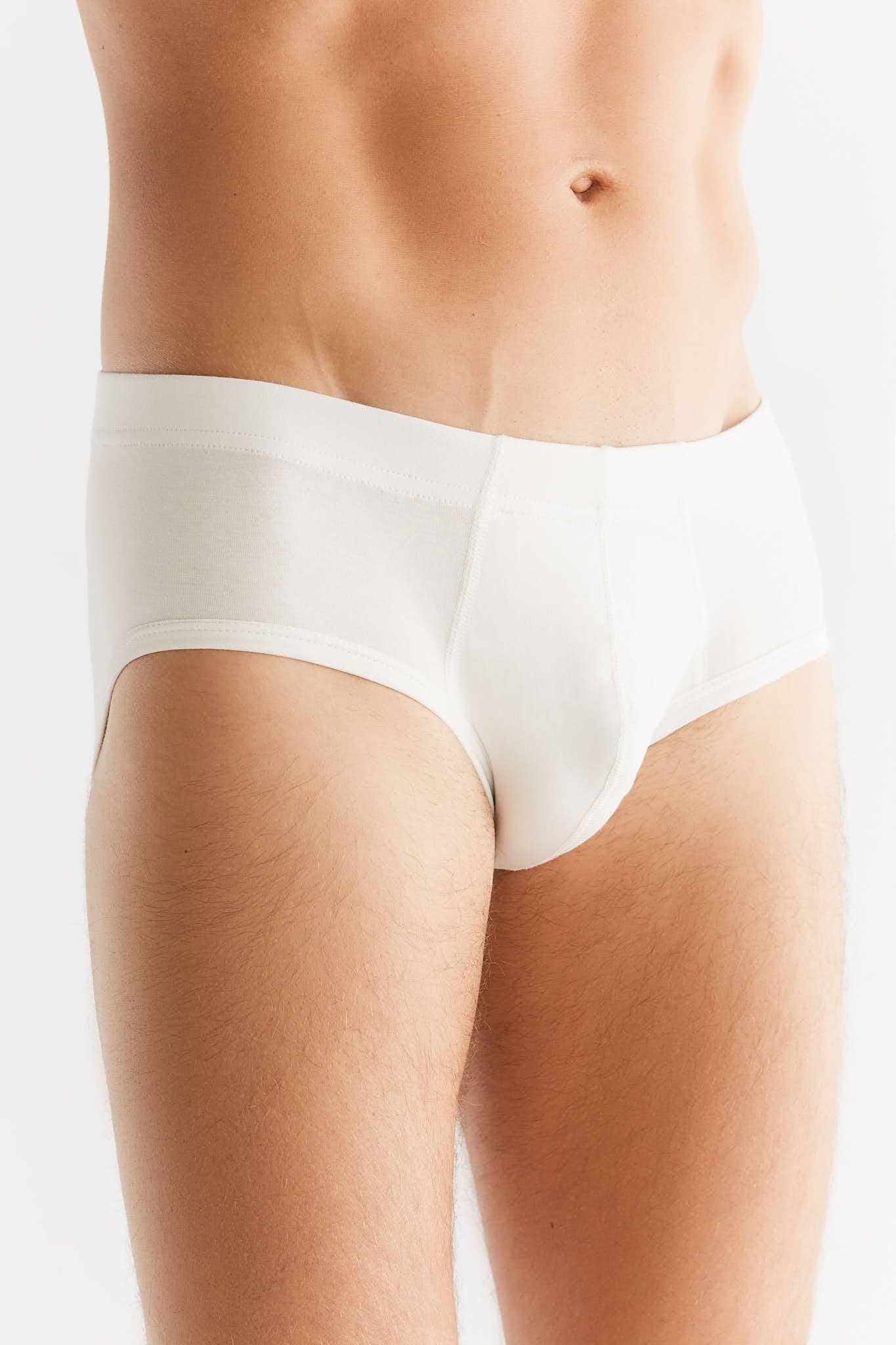 Man wearing stylish organic cotton briefs with elastic waistband, epitomising eco-friendly luxury and comfort.
