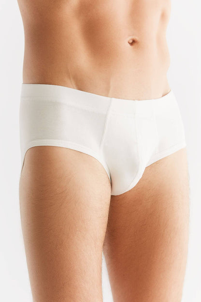 Man wearing stylish organic cotton briefs with elastic waistband, epitomising eco-friendly luxury and comfort.