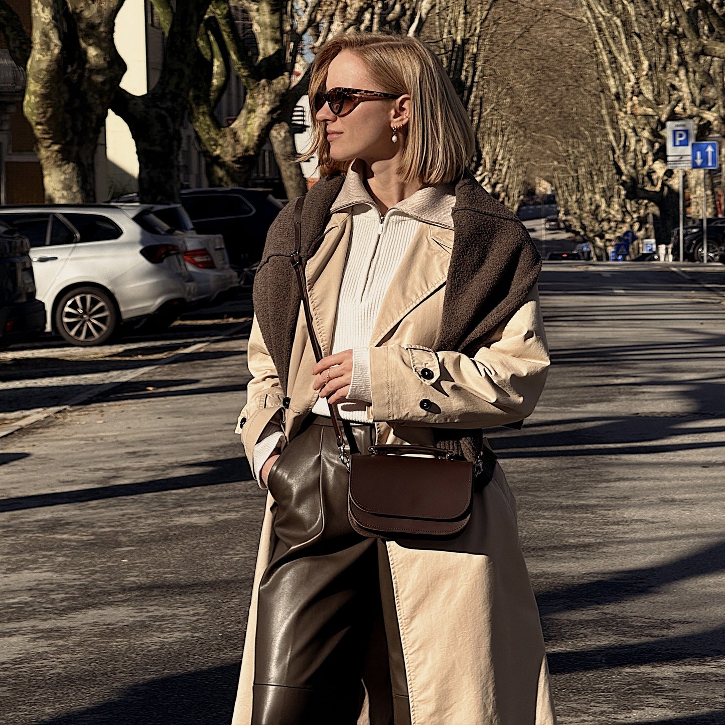 Detailed view of the Aura Luxury Handmade Dark Brown Leather Handbag featuring sophisticated cable stitching and lustrous silver nickel detailing, perfect for enhancing any outfit.
